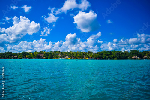 Tropical island with sky in the seven colors lake of Bacalar, Mexico 