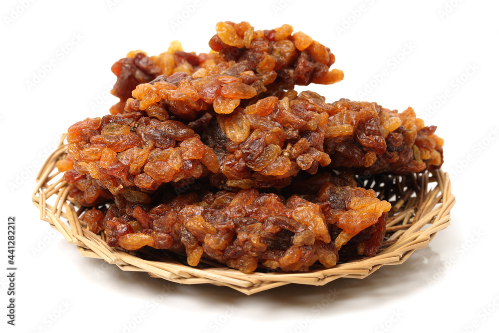 brown raisins on a white background brown raisins on a white background