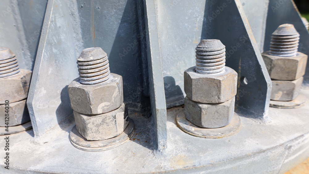 Nuts and screws on the metal base. close focus on the subject Nuts and screws on the metal base. close focus on the subject