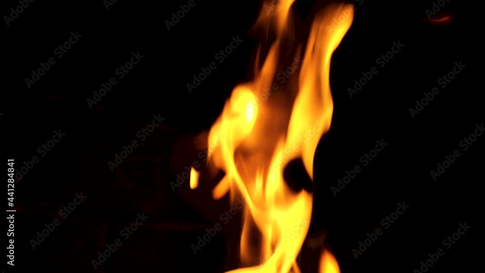 Fire burning in a chimney. Abstract slow motion flames in the dark Fire burning in a chimney. Abstract slow motion flames in the dark