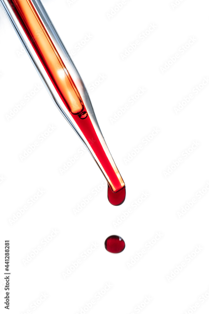 The hand holds a test tube with blood. The hand holds a test tube with blood.