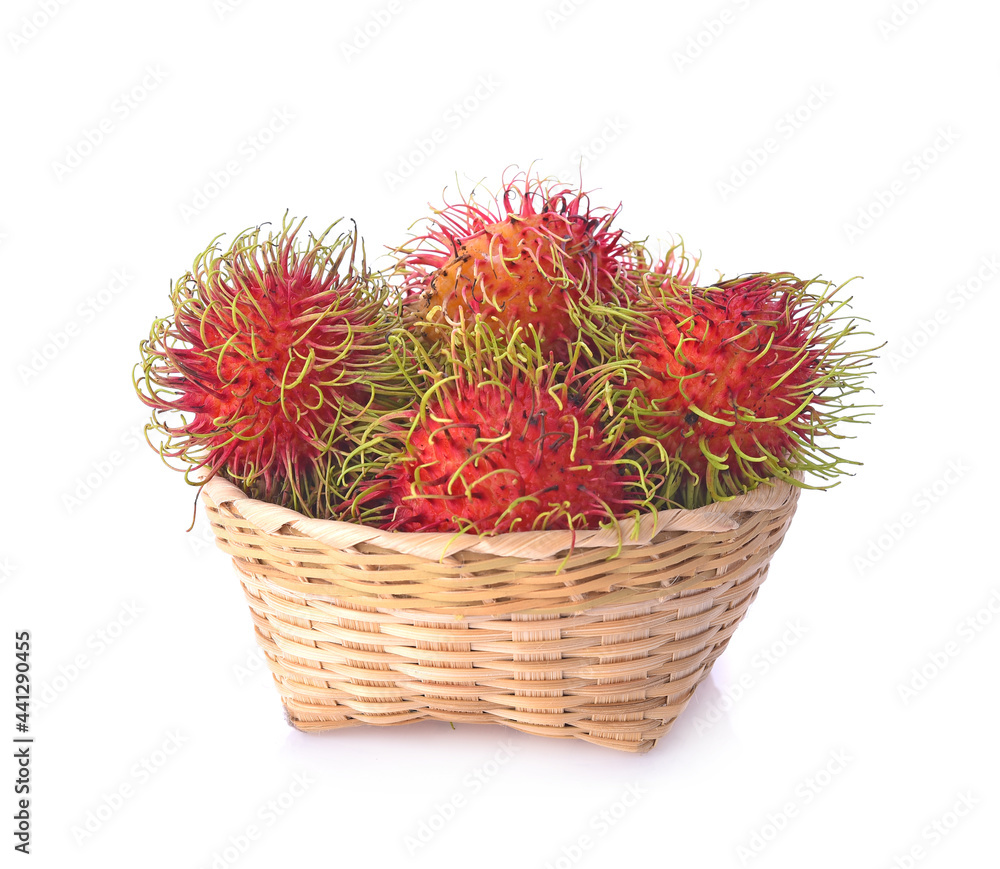 Fototapeta premium Rambutan in a bamboo basket on white background