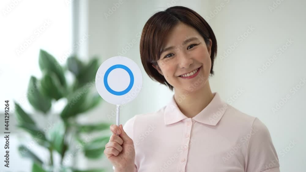 頷いて〇札を出す介護士