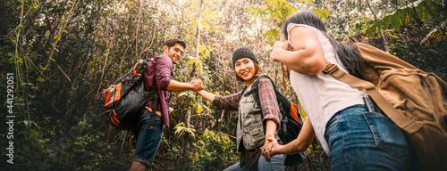 Tourists multiethnic friendship backpacking travel in the forest, happy freedom journey adventure concept.