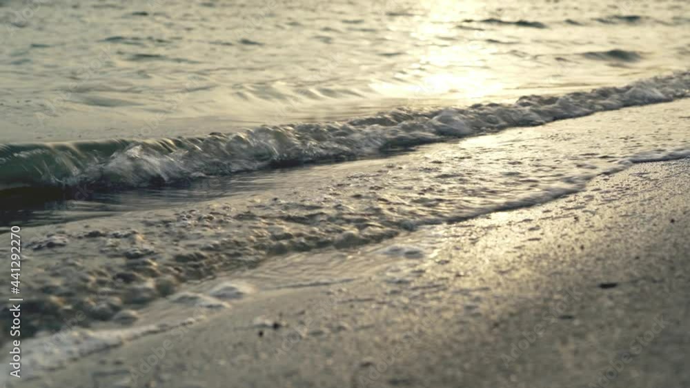 Sea waves slowly hitting sandy beach during late afternoon. Sea waves slowly hitting sandy beach during late afternoon.