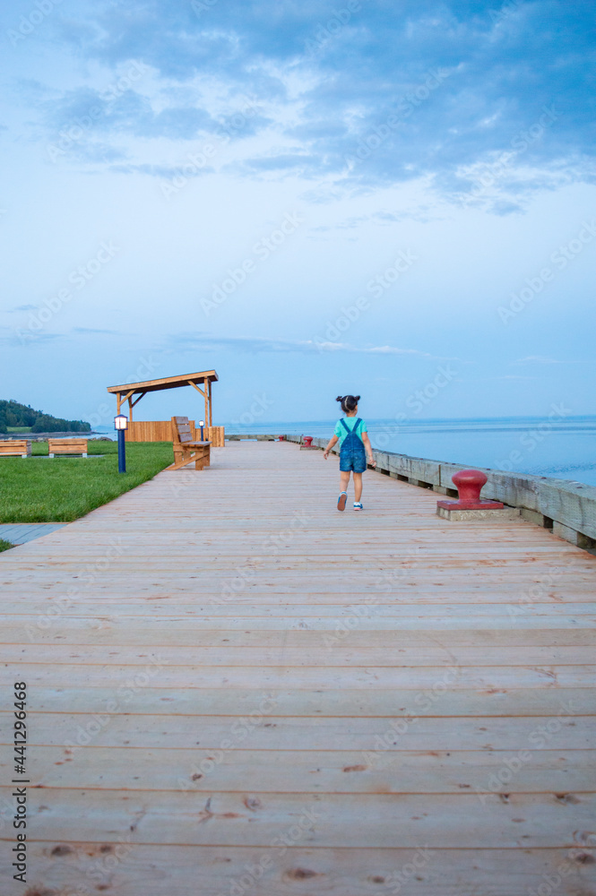Cute little girl walking. fleuve Saint-Laurent, La Malbaie, Charlevoix, quebec, Canada Cute little girl walking. fleuve Saint-Laurent, La Malbaie, Charlevoix, quebec, Canada