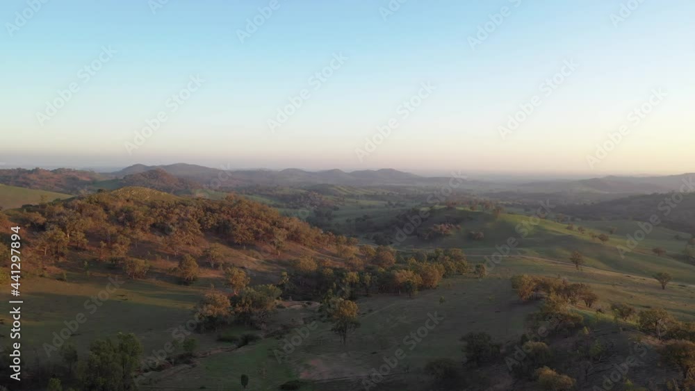 Aerial wide shot flying over green rustic hills in Mudgee, New South Wales, Australia. Aerial wide shot flying over green rustic hills in Mudgee, New South Wales, Australia.
