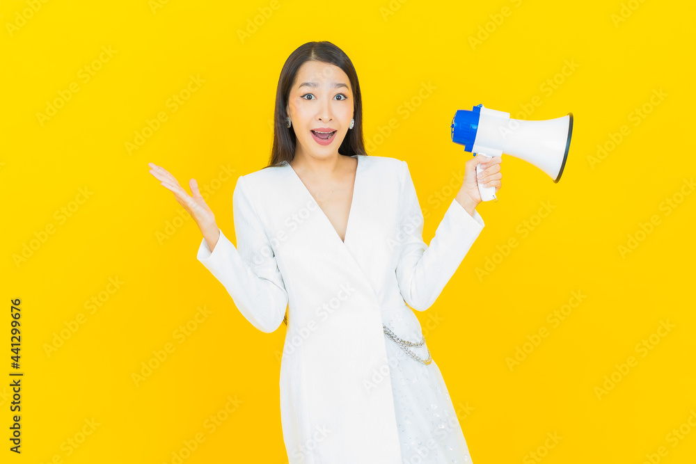 Portrait beautiful young asian woman smile with megaphone