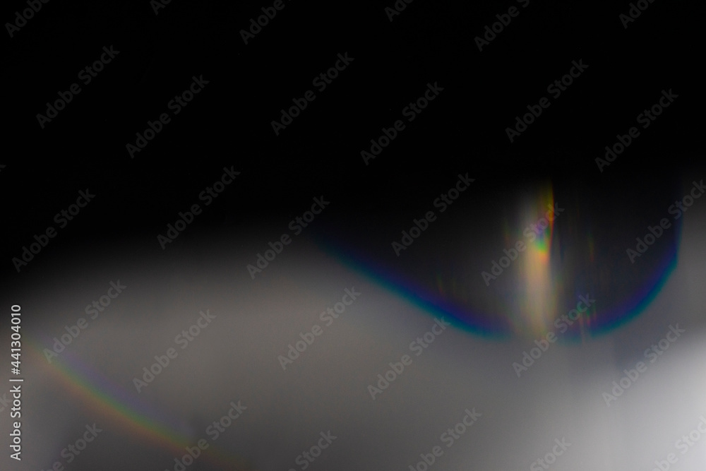 crystal light leak effect for photo overlay. prism lens flare bokeh abstract with glow, colorful, and magical lights on black background.