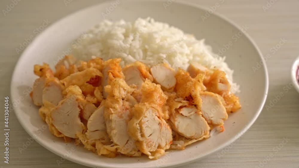 fried chicken topped on rice with spicy dipping sauce fried chicken topped on rice with spicy dipping sauce