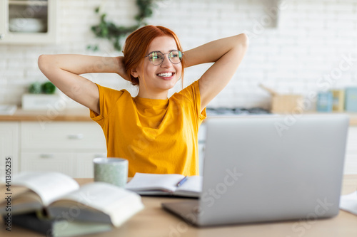 Fotografie Beautiful young student woman, throwing your hands behind your head, resting aft