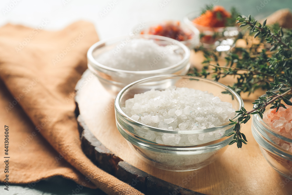 Composition with different salt and thyme on table, closeup Composition with different salt and thyme on table, closeup