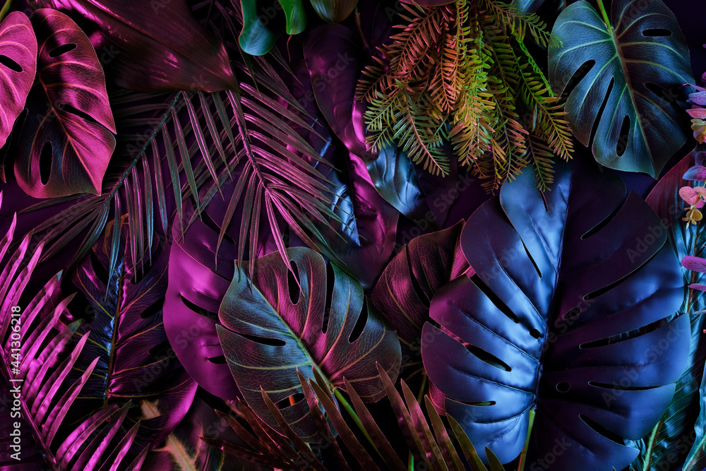 Tropical dark trend jungle in neon illuminated lighting. Exotic palms and plants in retro style. - obrazy, fototapety, plakaty 