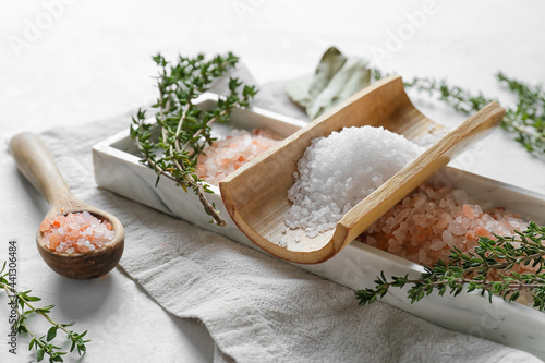 Fototapeta Naklejka Na Ścianę i Meble -  Composition with different salt and herbs on light background, closeup