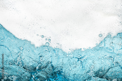 White foam clear blue water background closeup, sea or ocean foam wave border, froth bubbles texture, lather backdrop, soap suds pattern, soapy detergent, foamy bath surface, shower, clean and wash 