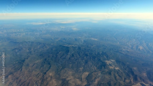 Flying Over Mountainous Terrain, Clear Sky, Blue Atmosphere photo