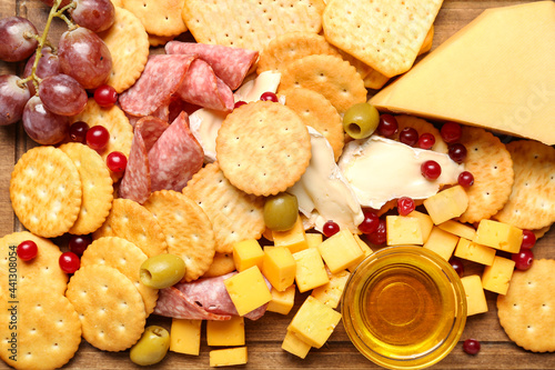 Fototapeta Naklejka Na Ścianę i Meble -  Board with tasty crackers with cheese and snacks, closeup