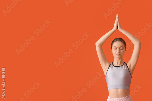 Sporty young woman doing yo...