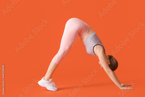 Sporty young woman doing yo...