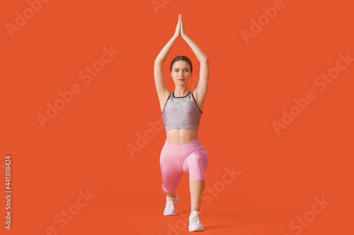 Sporty young woman doing yo...