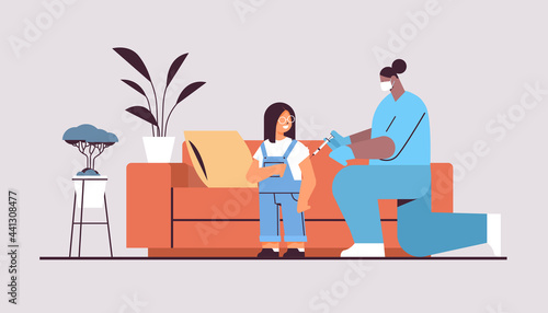 female doctor in mask vaccinating little child patient fight against coronavirus vaccine development concept
