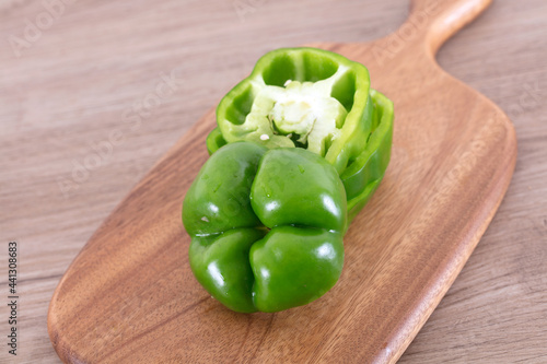 Fresh green pepper on cutting board