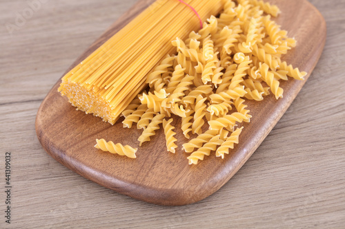 Two kinds of spaghetti on cutting board