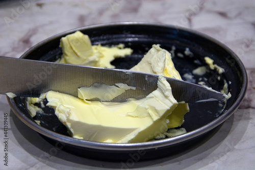 Butter in a butter dish, cut off with a knife.