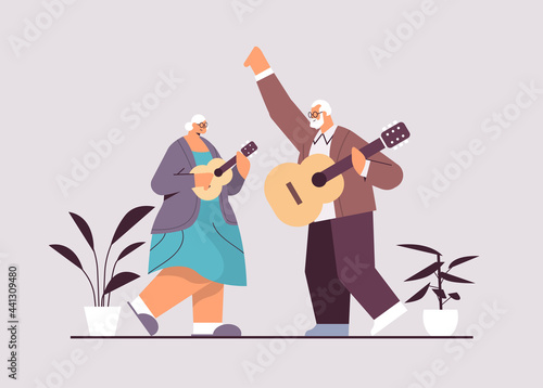 senior couple playing guitar grandparents having fun active old age concept