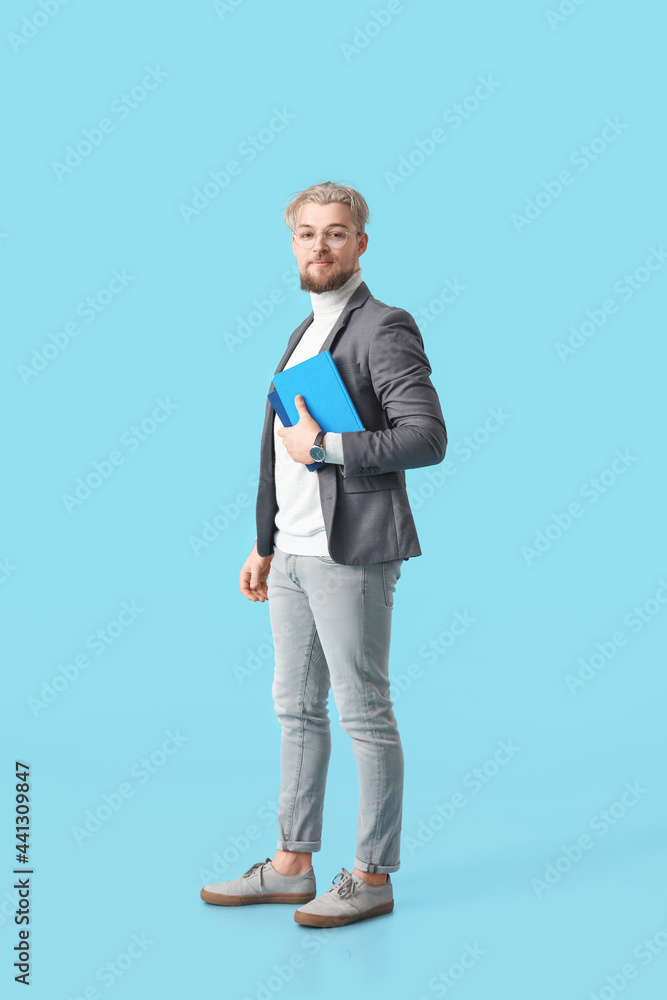 Male student with books on color background Male student with books on color background