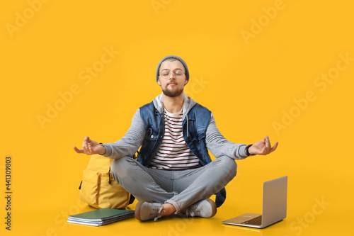 Meditating male student on ...