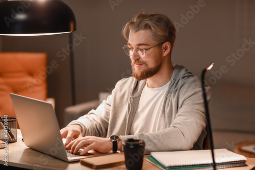 Young man studying online a...