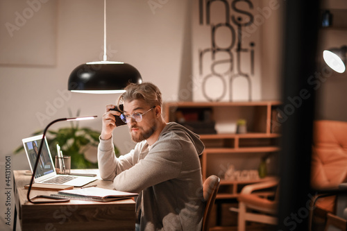 Young man studying online a...