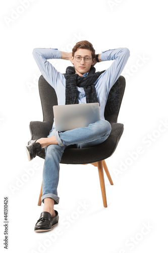 Young man with laptop sitti...