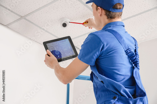 Worker installing alarm sys...