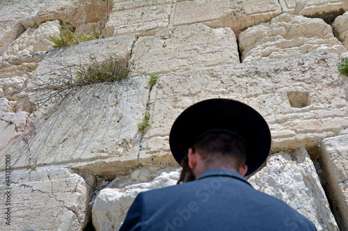 Jewish orthodox man pray under the Western Wal in Jerusalem old
