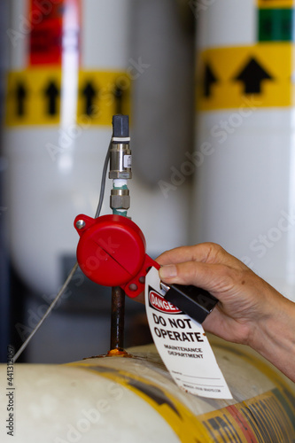 worker applying small valve lockout