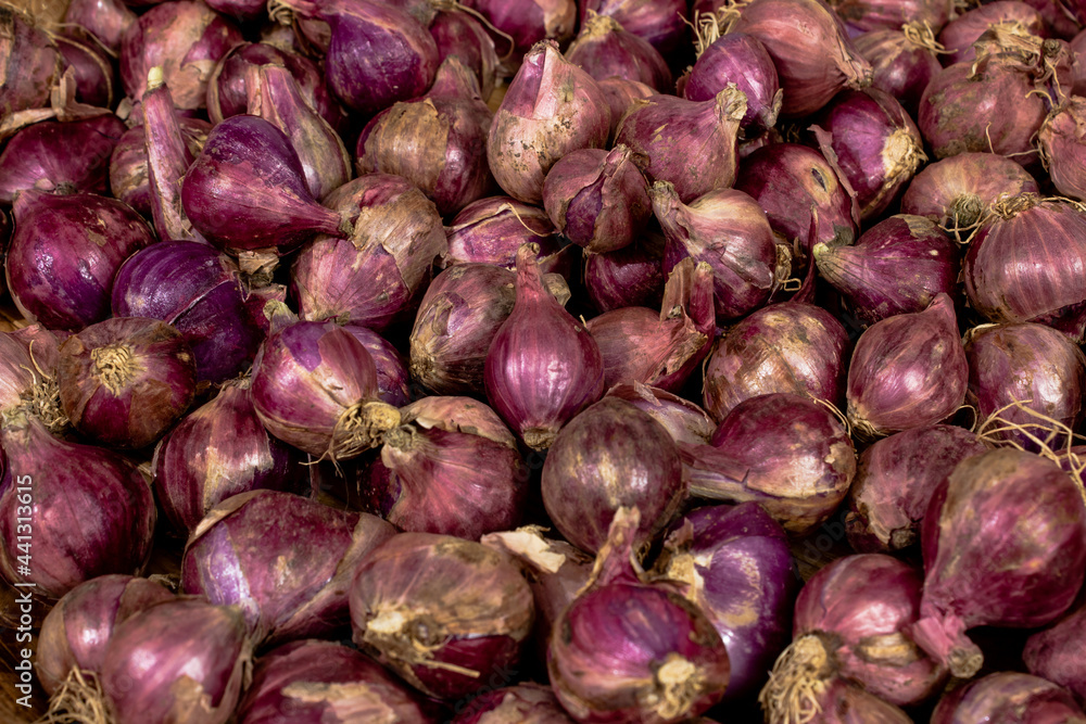 Top view of onions (shallots) spread in market Top view of onions (shallots) spread in market