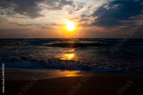 Sunset sunrise on the sea. Sea waves. Beach. Evening.