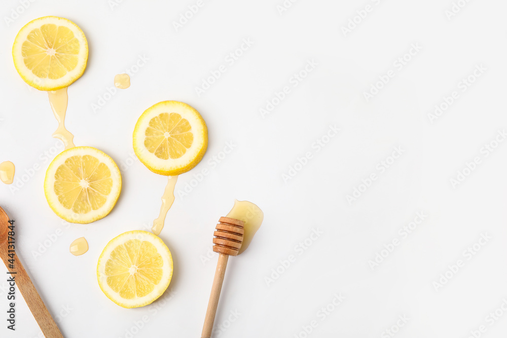 Composition with lemon slices and honey on white background Composition with lemon slices and honey on white background