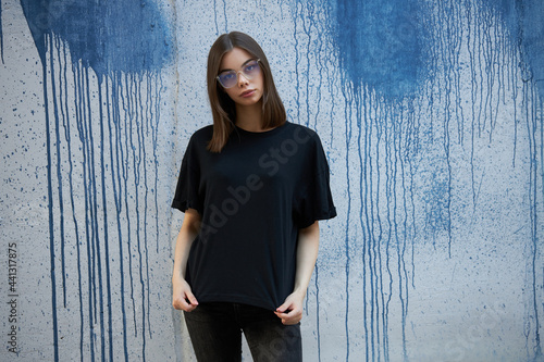 Photography Woman or girl wearing black blank cotton t-shirt with space for your logo, mock