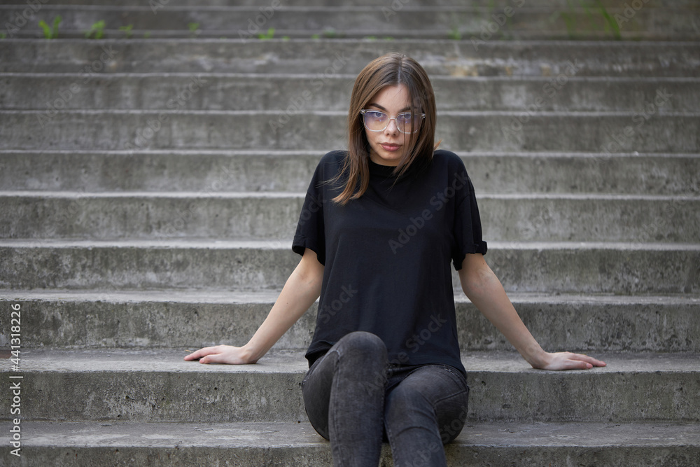 Woman or girl wearing black blank cotton t-shirt with space for your logo,  mock up or design in casual urban style Stock 写真 | Adobe Stock