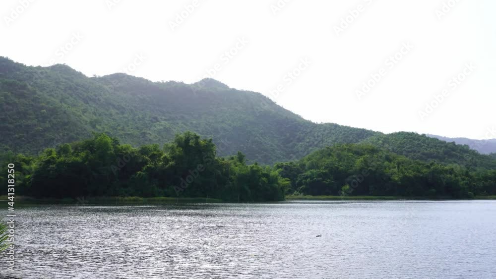 In summer, in a natural resting place amidst the shady atmosphere of the mountains river and clear sky In summer, in a natural resting place amidst the shady atmosphere of the mountains river and clear sky