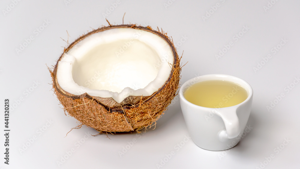 Coconut oil with a half of a coconut Coconut oil with a half of a coconut