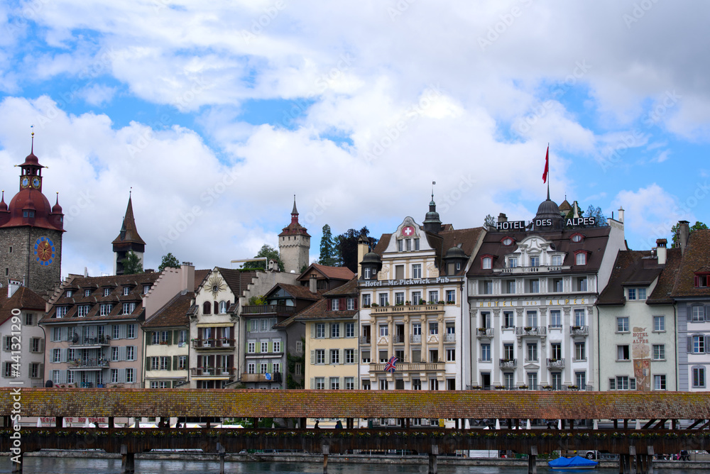 Naklejka premium Medieval old town of Lucerne with famous Kappelbrücke (Chapel Bridge) on a cloudy summer day with river Reuss. Photo taken June 22nd, 2021, Luzern, Switzerland.