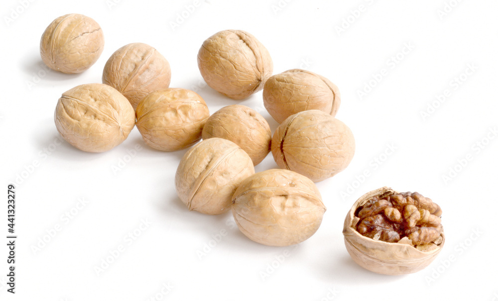 Walnuts in shell and one shelled isolated on white background Walnuts in shell and one shelled isolated on white background
