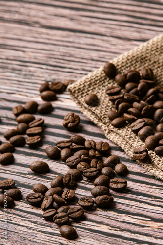 Roasted coffee beans on old wooden table © Expert Mind