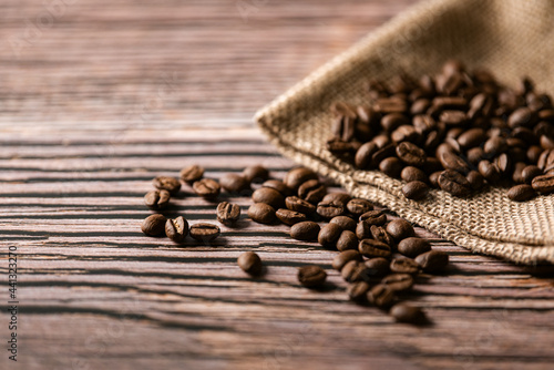 Roasted coffee beans on old wooden table © Expert Mind