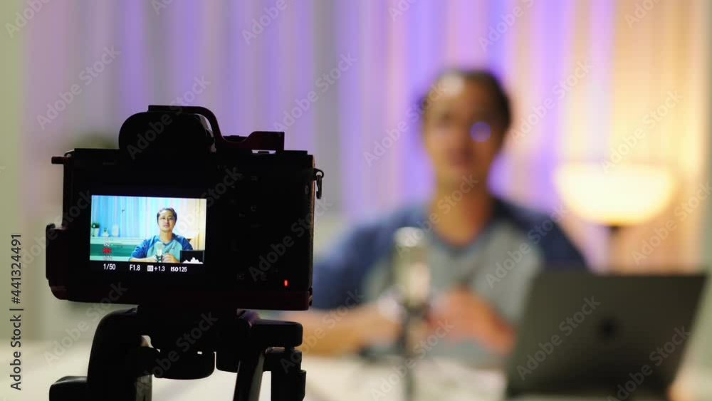A Vlogger Asian man is broadcasting a podcast at home. With recording and video recording equipment To broadcast live to his audience via social media A Vlogger Asian man is broadcasting a podcast at home. With recording and video recording equipment To broadcast live to his audience via social media