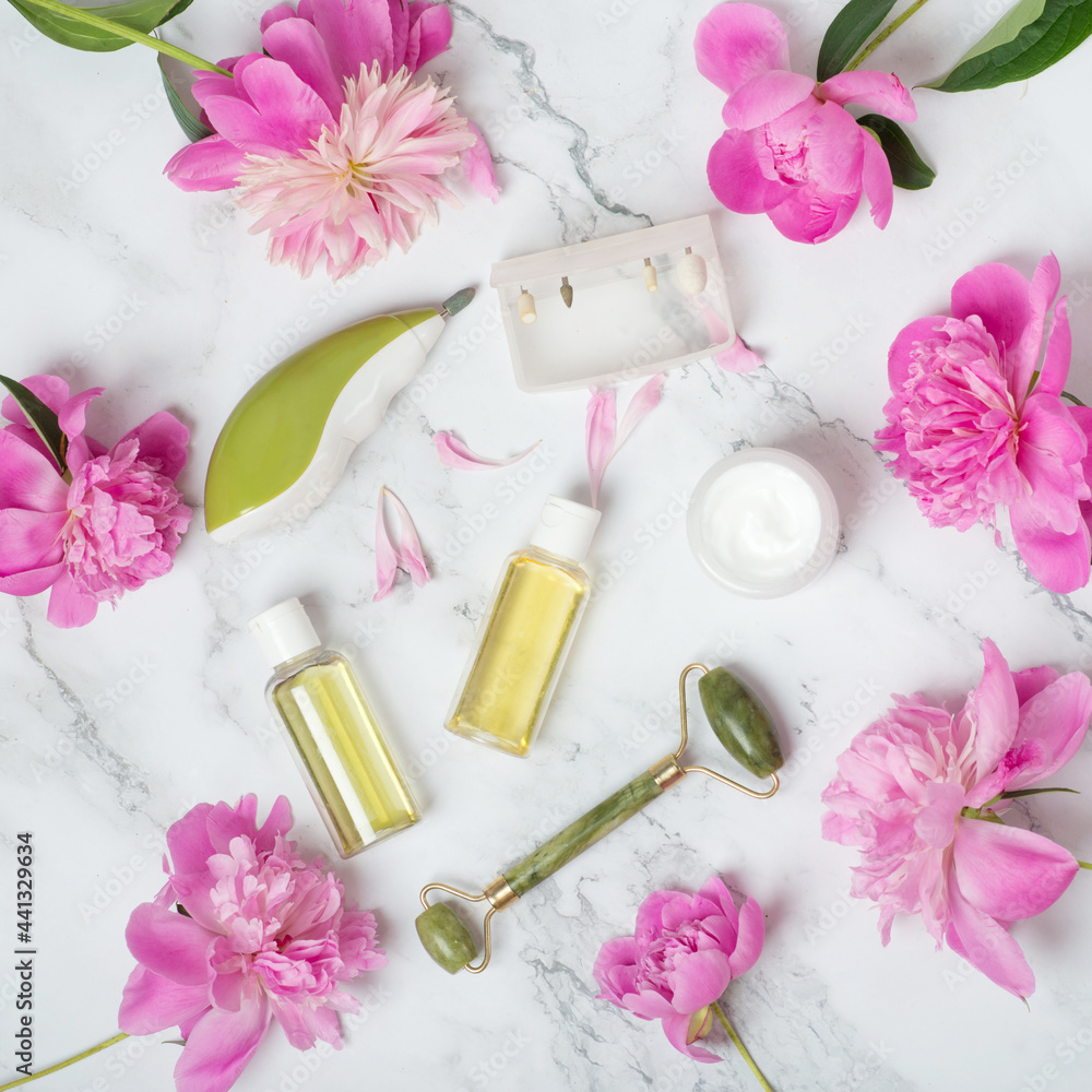 face care, peonies on a marble table. face roller, cream, hand care, peonies, manicure milling cutter face care, peonies on a marble table. face roller, cream, hand care, peonies, manicure milling cutter